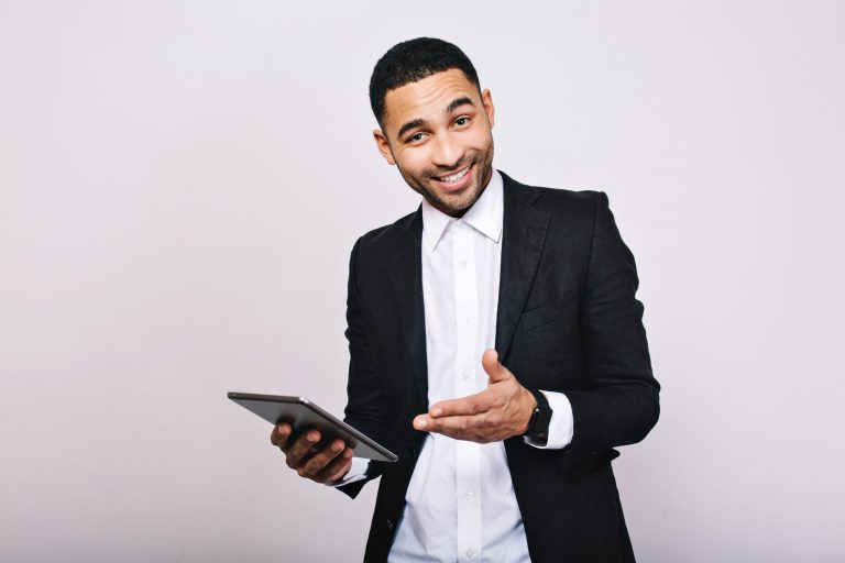 stylish-young-handsome-man-white-shirt-black-jacket-with-tablet-smiling-achieve-success-great-work-expressing-true-positive-emotions-businessman-smart-worker-scaled